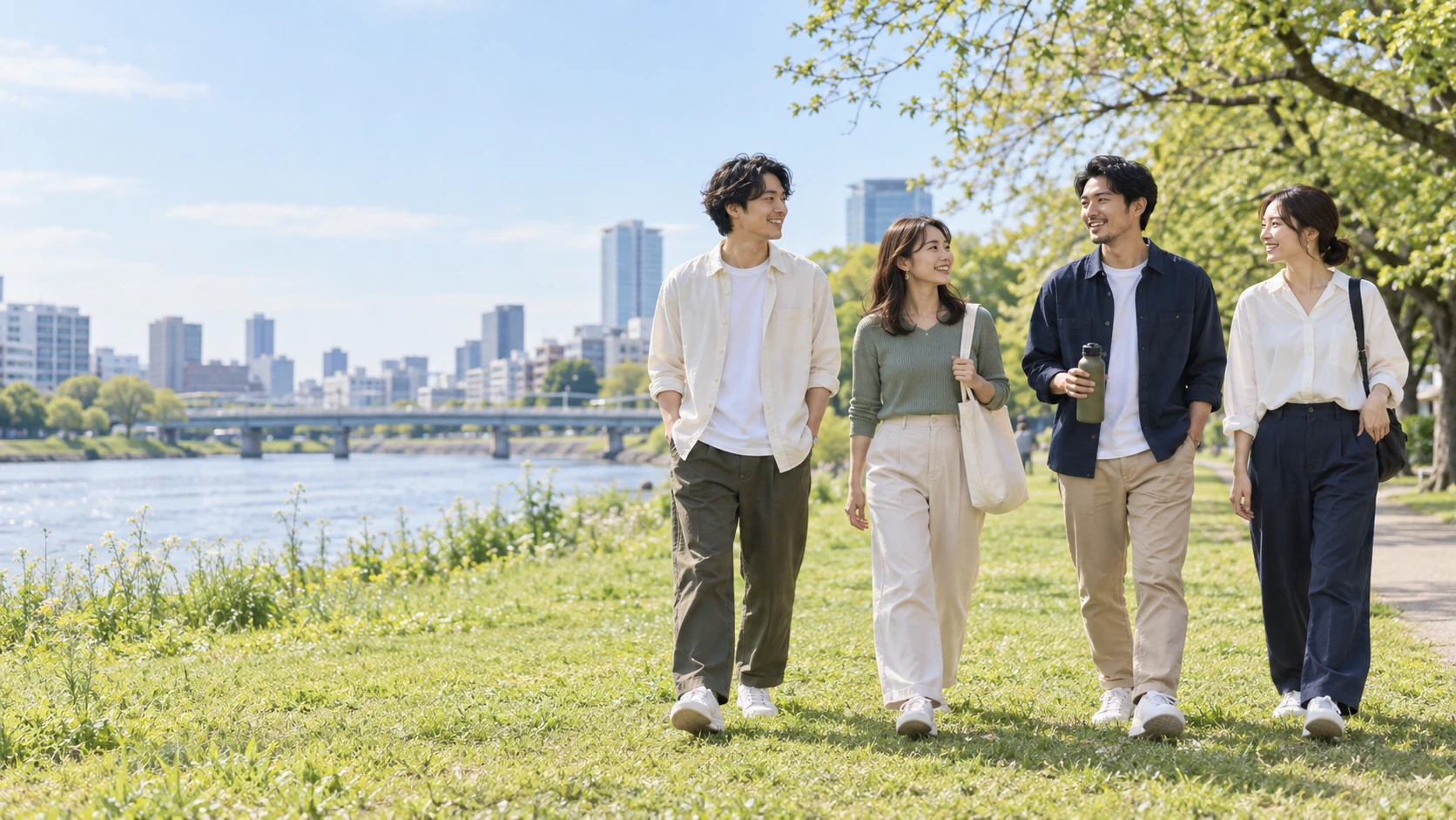 川沿いで交流する若い世代のイメージ画像